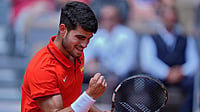 | Photo: AP/Andy Wong : Carlos Alcaraz reacts after scoring a point against Felix Auger-Aliassime 